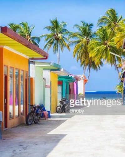 Shopping street with typically colorful house facades in Maafushi a local island in the Maldives.