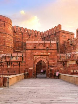 Agra Fort - Historic red sandstone fort of medieval India also known as the Red Fort Agra at sunrise. Agra Fort is a UNESCO World Heritage site in the city of Agra India.