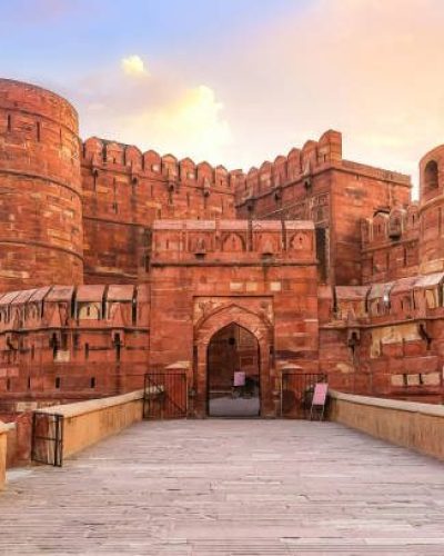 Agra Fort - Historic red sandstone fort of medieval India also known as the Red Fort Agra at sunrise. Agra Fort is a UNESCO World Heritage site in the city of Agra India.