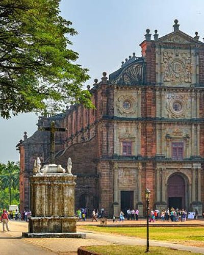 Old Goa, India - November 13, 2012: Unidentified tourists visit to the famous landmark - Basilica of Bom Jesus (Borea Jezuchi Bajilika) in Old Goa, India. Basilica is a UNESCO World Heritage Site.